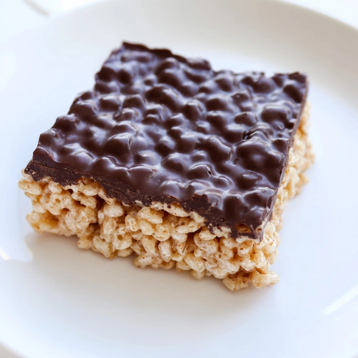 Golden, gooey Rice Krispie Treats, cut into squares, ready for a sweet, satisfying bite.