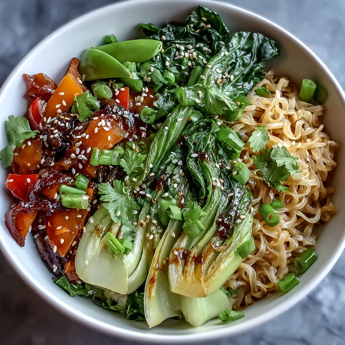 Colorful stir-fried shirataki noodles tossed with bok choy, bell pepper, and snow peas in a zesty ginger sesame sauce.