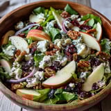 Freshly tossed Mixed Greens and Apple Bowl with crisp apples, walnuts, and tangy feta in a shiny cider vinaigrette.