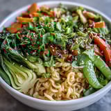 Vibrant shirataki noodle bowl with crisp Asian vegetables and fragrant ginger sauce, perfect for a healthy low-carb meal.