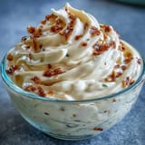 Homemade chipotle lime mayonnaise in a glass jar, showcasing its rich, creamy texture and vibrant color.