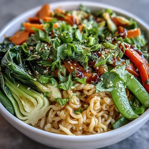 Vibrant shirataki noodle bowl with crisp Asian vegetables and fragrant ginger sauce, perfect for a healthy low-carb meal.