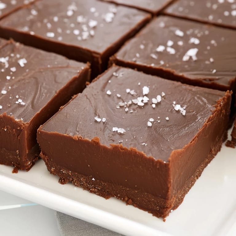 Creamy homemade fudge, cooling and glistening, a decadent sweet treat ready to slice and serve.