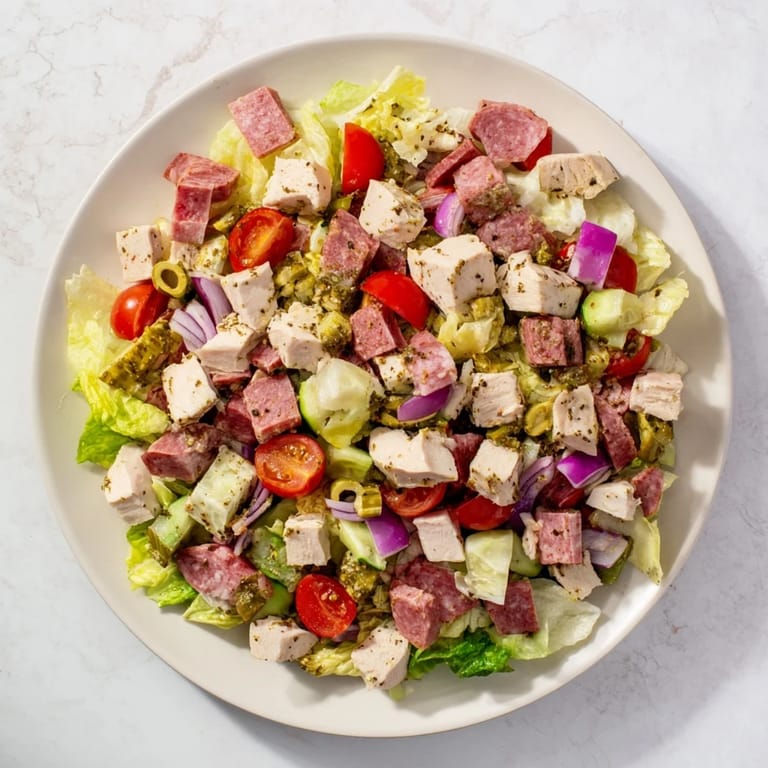 Freshly tossed Italian Deli Chopped Chicken Salad with colorful vegetables and herbs, ready to serve for lunch or dinner.