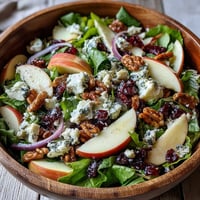 Freshly tossed Mixed Greens and Apple Bowl with crisp apples, walnuts, and tangy feta in a shiny cider vinaigrette.