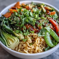 Vibrant shirataki noodle bowl with crisp Asian vegetables and fragrant ginger sauce, perfect for a healthy low-carb meal.