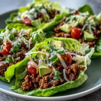 Juicy turkey taco lettuce wraps piled high with fresh toppings, perfect for a healthy meal.