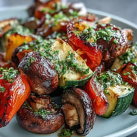 Colorful grilled veggie kabobs with a vibrant, fresh chimichurri sauce.